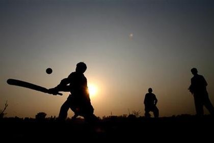 Children play cricket near the Wagah border crossing with India, near Lahore, in Pakistan, where the English cricket team paid a visit, 6 December 2005. REUTERS/ Jason O'Brien.